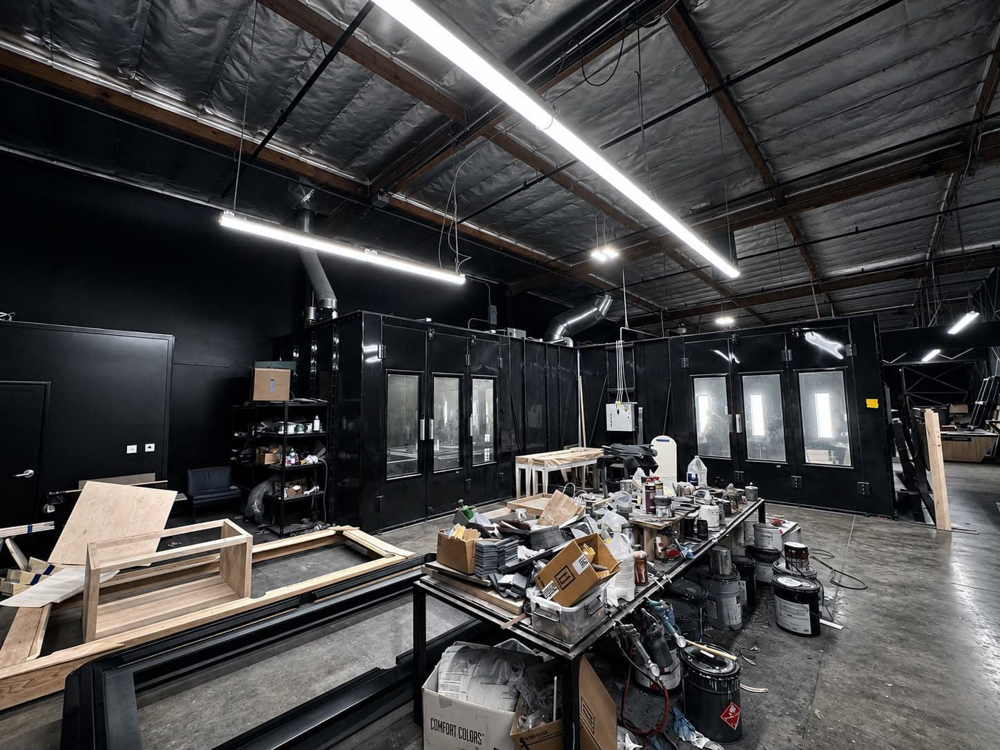 Finishing booth and workbenches inside the Elevate Customs Los Angeles factory