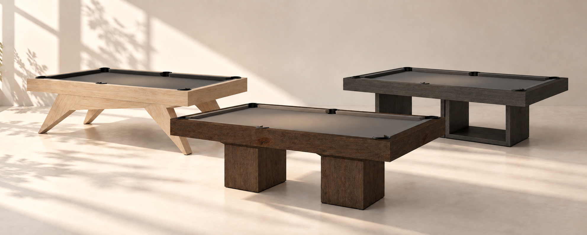 Three Alder Collection pool tables in a sunlit plaster room